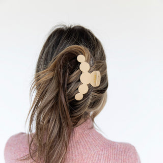 Person with a stylish hair accessory on a plain background